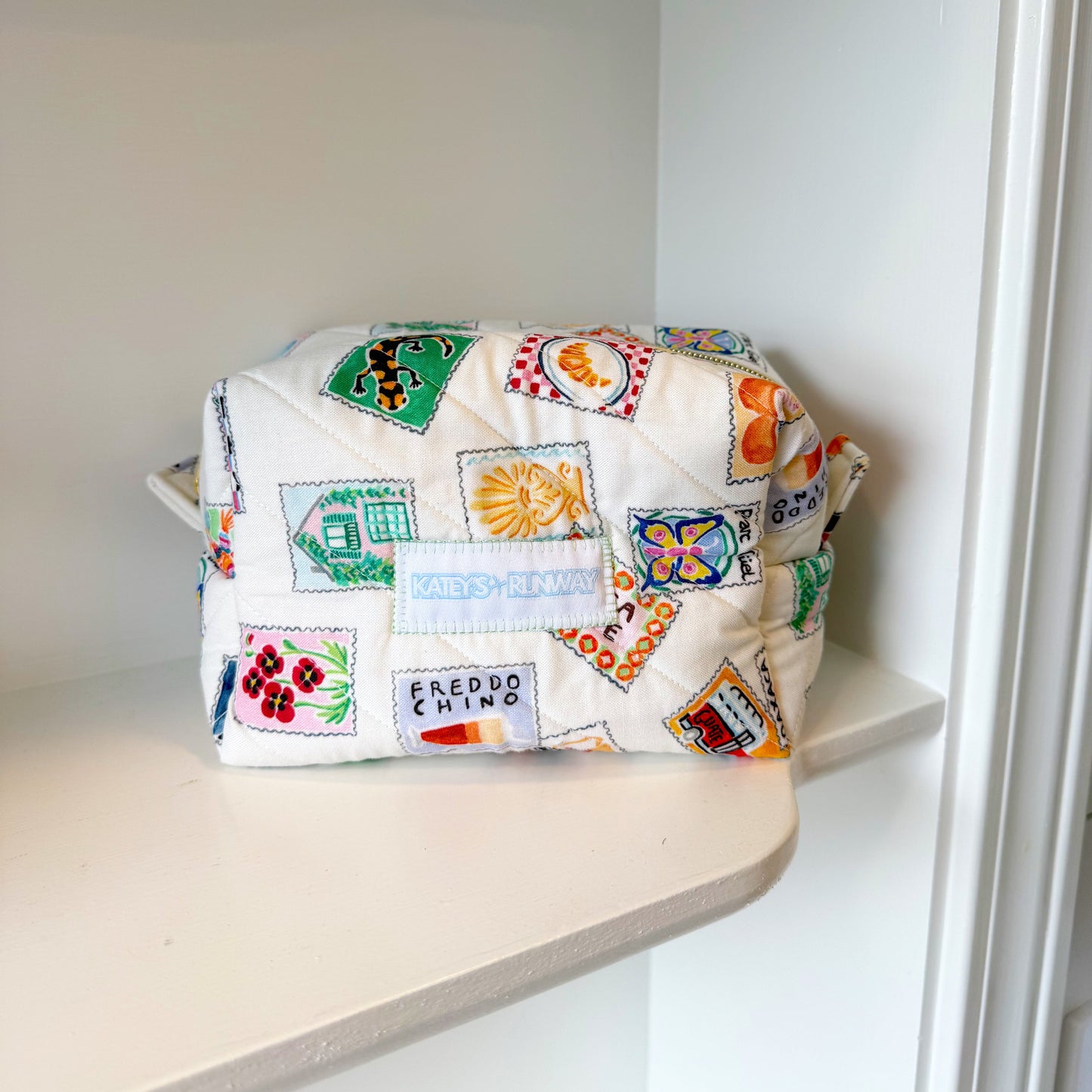 Colorful patterned bag on a shelf in a white room