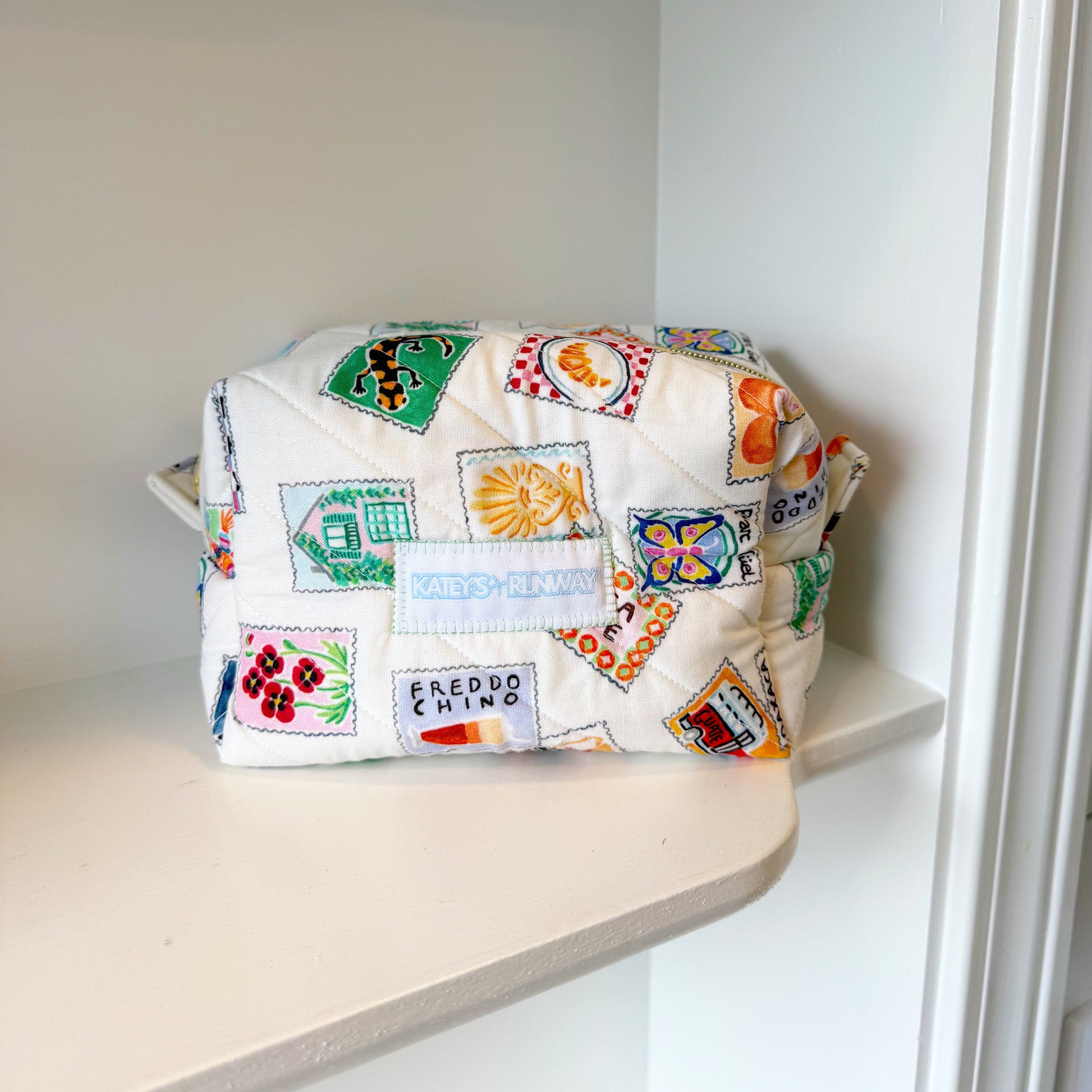 Colorful patterned bag on a shelf in a white room