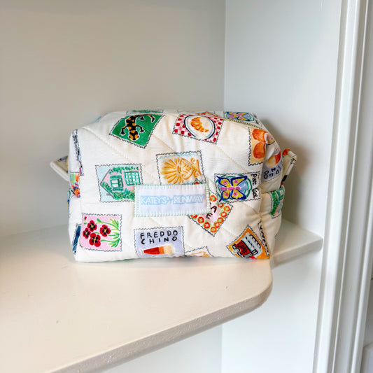 Colorful patterned bag on a shelf in a white room